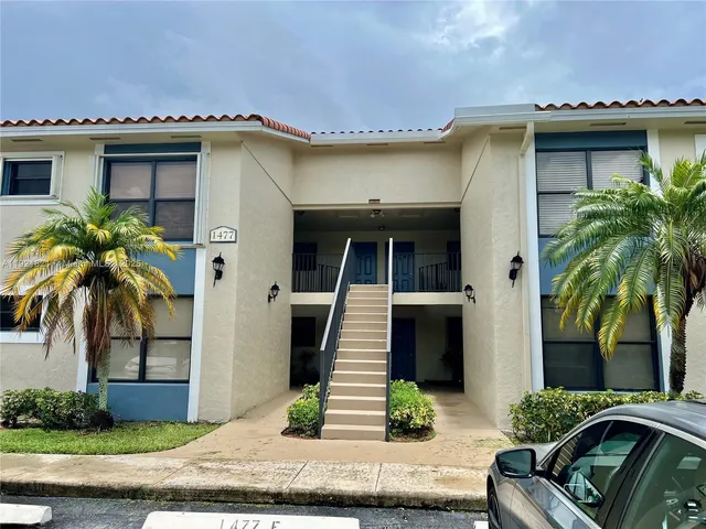 a view of a house with a patio and a yard