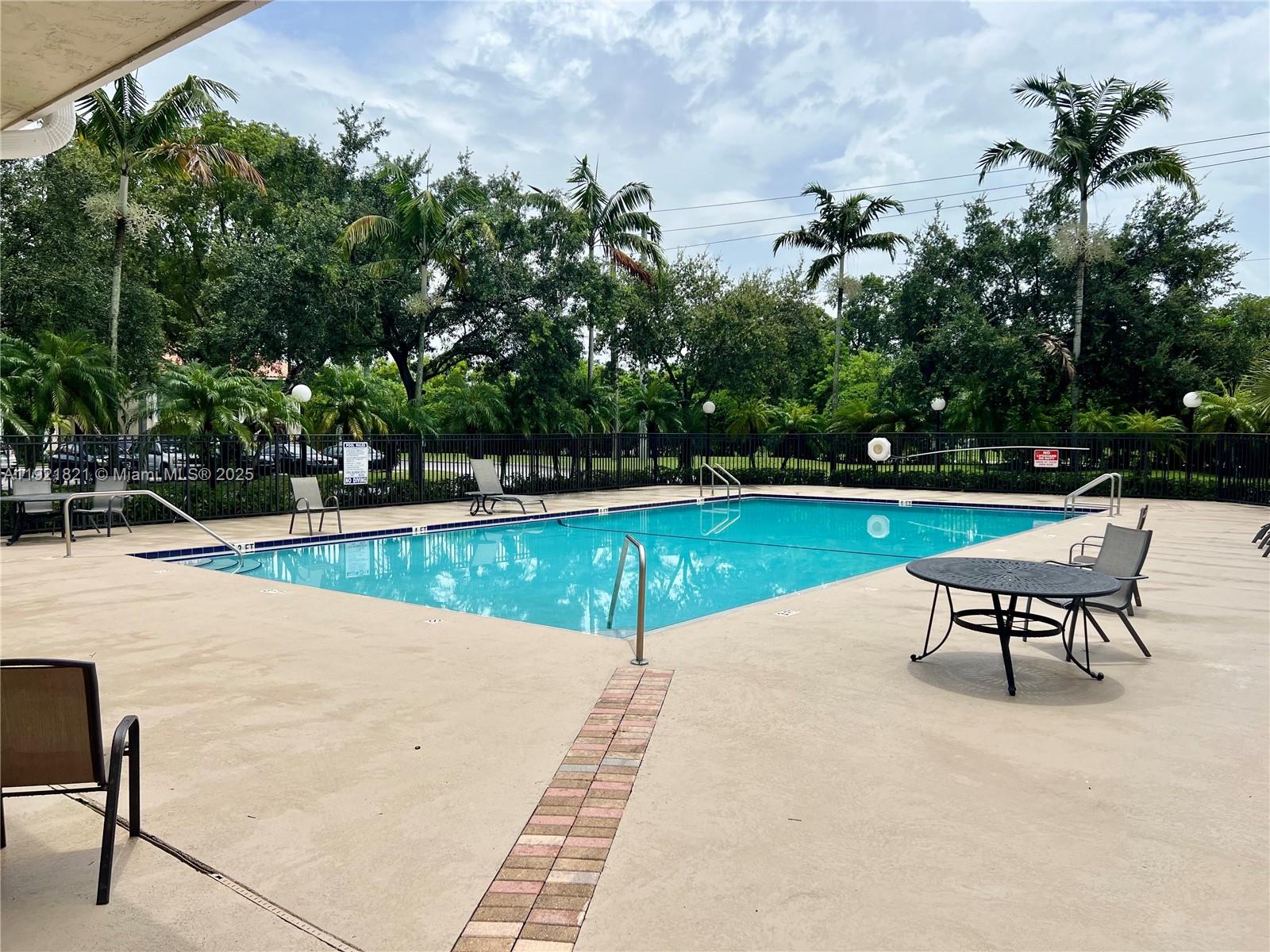 1477 Lake Crystal Drive, Unit F West Palm Beach, FL 33411 - Photo 15 of 16 a swimming pool with outdoor seating and yard