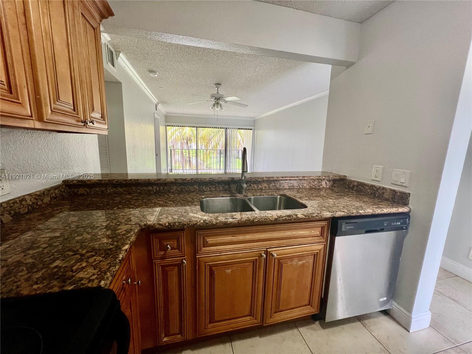 1477 Lake Crystal Drive, Unit F West Palm Beach, FL 33411 - Photo 2 of 16 a kitchen with granite countertop a sink and a stove