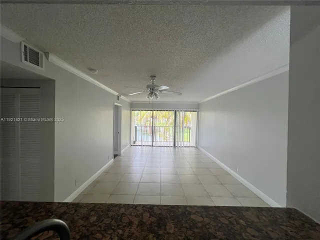 a view of hallway with wooden floor and chandelier