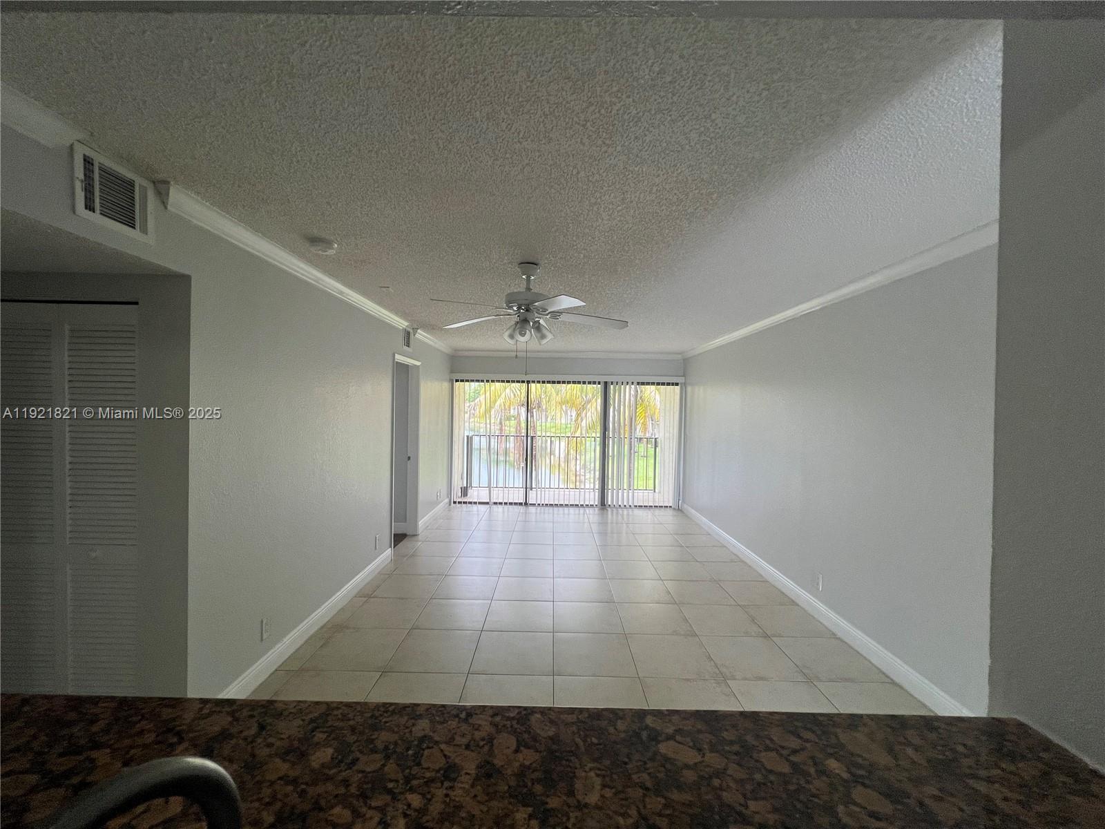 1477 Lake Crystal Drive, Unit F West Palm Beach, FL 33411 - Photo 4 of 16 a view of hallway with wooden floor and chandelier