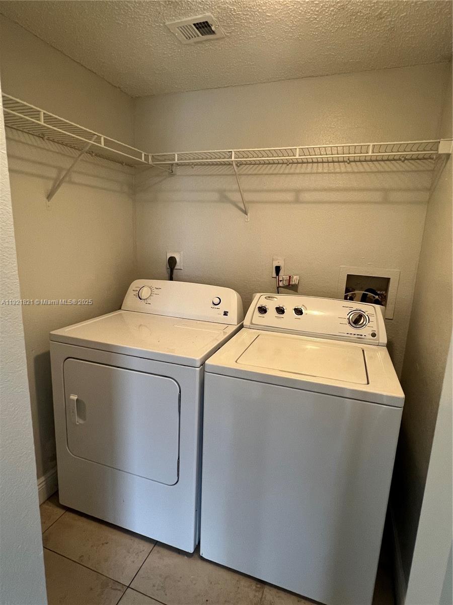 1477 Lake Crystal Drive, Unit F West Palm Beach, FL 33411 - Photo 10 of 16 a utility room with dryer and washer
