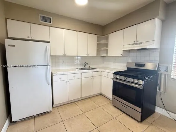 a kitchen with cabinets and appliances