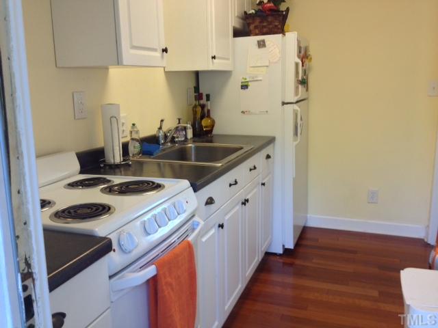 709 Daniels Street, Unit A Raleigh, NC 27605 - Photo 2 of 6 a kitchen with granite countertop a sink stove and cabinets