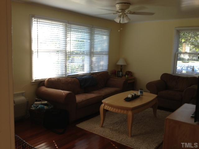 709 Daniels Street, Unit A Raleigh, NC 27605 - Photo 4 of 6 a living room with furniture and a window