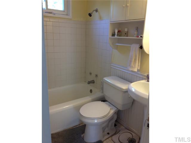 709 Daniels Street, Unit A Raleigh, NC 27605 - Photo 5 of 6 a white toilet sitting next to a bath tub