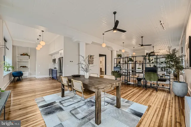 a living room with lots of furniture and wooden floor