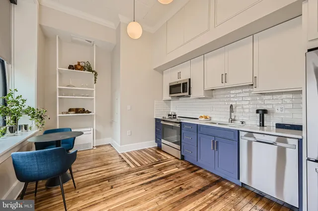 a kitchen with granite countertop a sink and cabinets