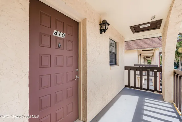 hallway view with wooden floor and windows