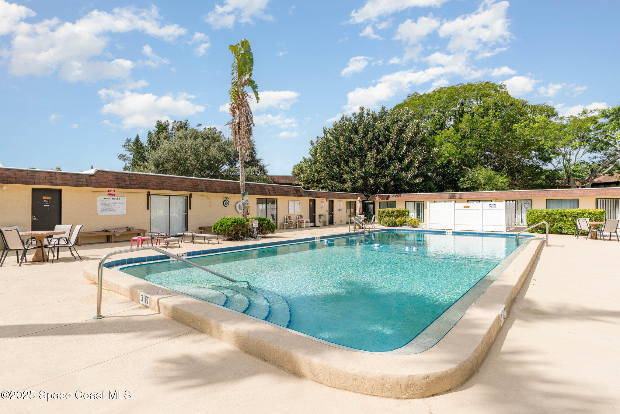 205 Palmetto Avenue, Unit 410 Merritt Island, FL 32953 - Photo 16 of 19 a view of a swimming pool with a patio