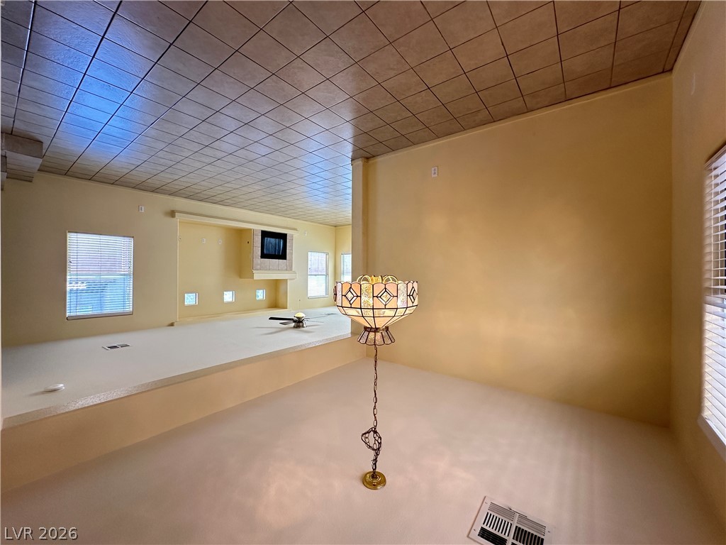 9032 Rutherford Grove Street Las Vegas, NV 89148 - Photo 5 of 24 A spacious living area with a built-in fireplace, ready for your personalized touch.