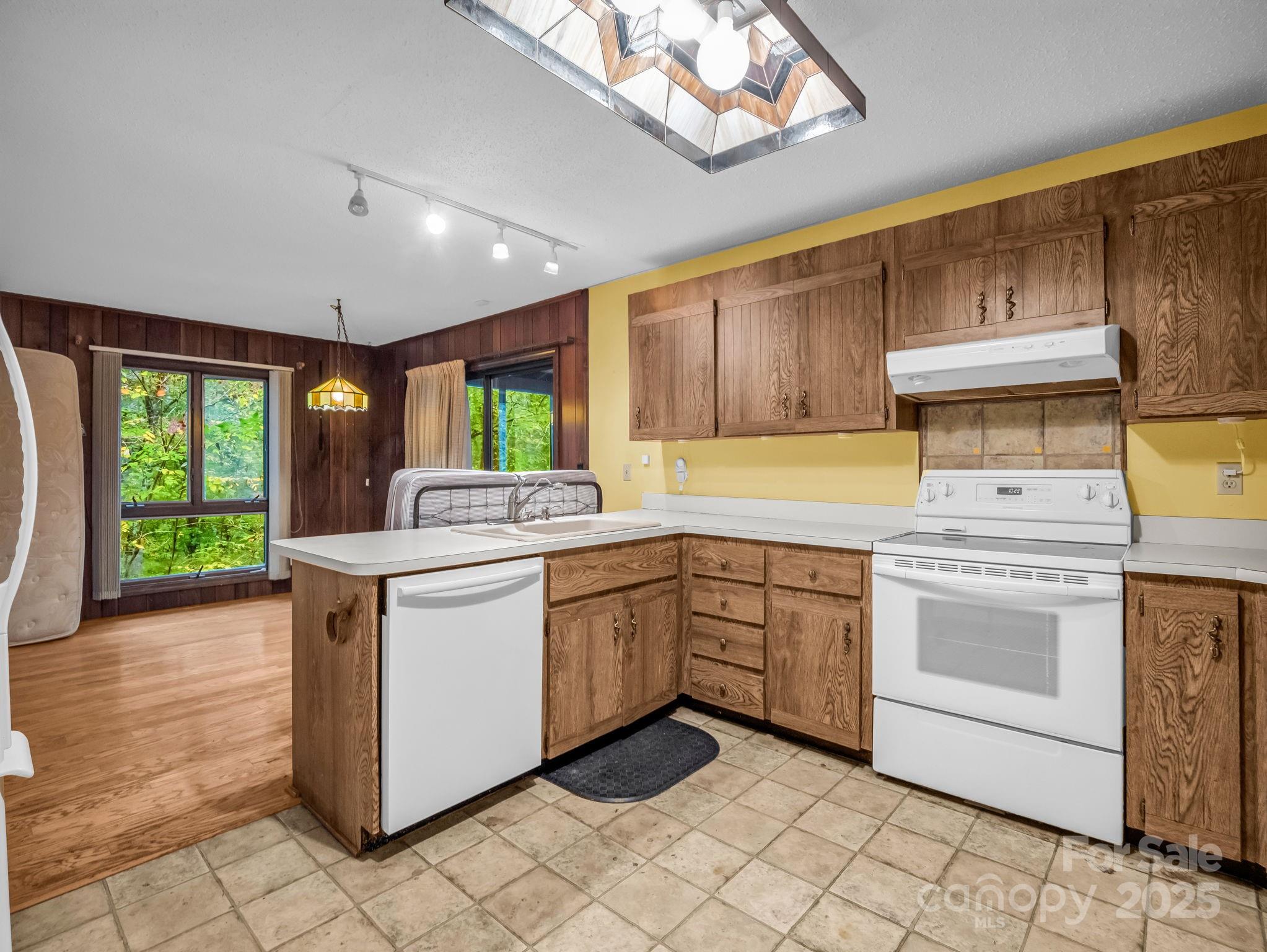 421 Chickadee Lane Brevard, NC 28712 - Photo 11 of 32 a kitchen with a stove sink and cabinets