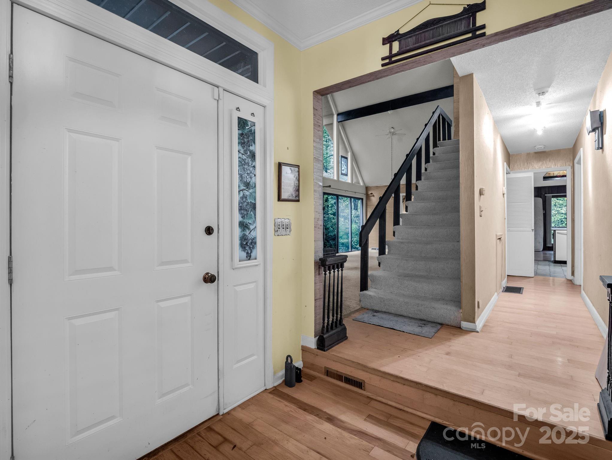 421 Chickadee Lane Brevard, NC 28712 - Photo 18 of 32 a view of a hallway with wooden floor and staircase