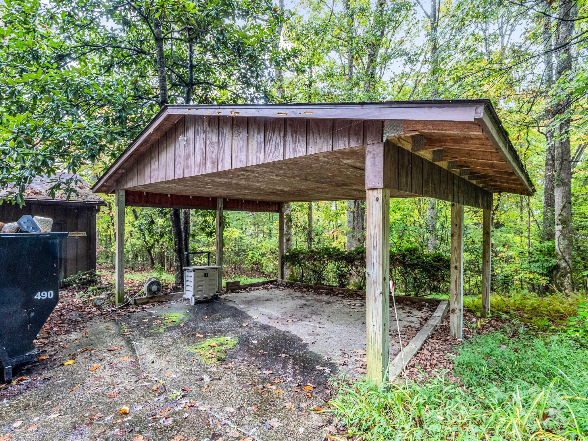 421 Chickadee Lane Brevard, NC 28712 - Photo 28 of 32 a backyard of a house with large trees and plants