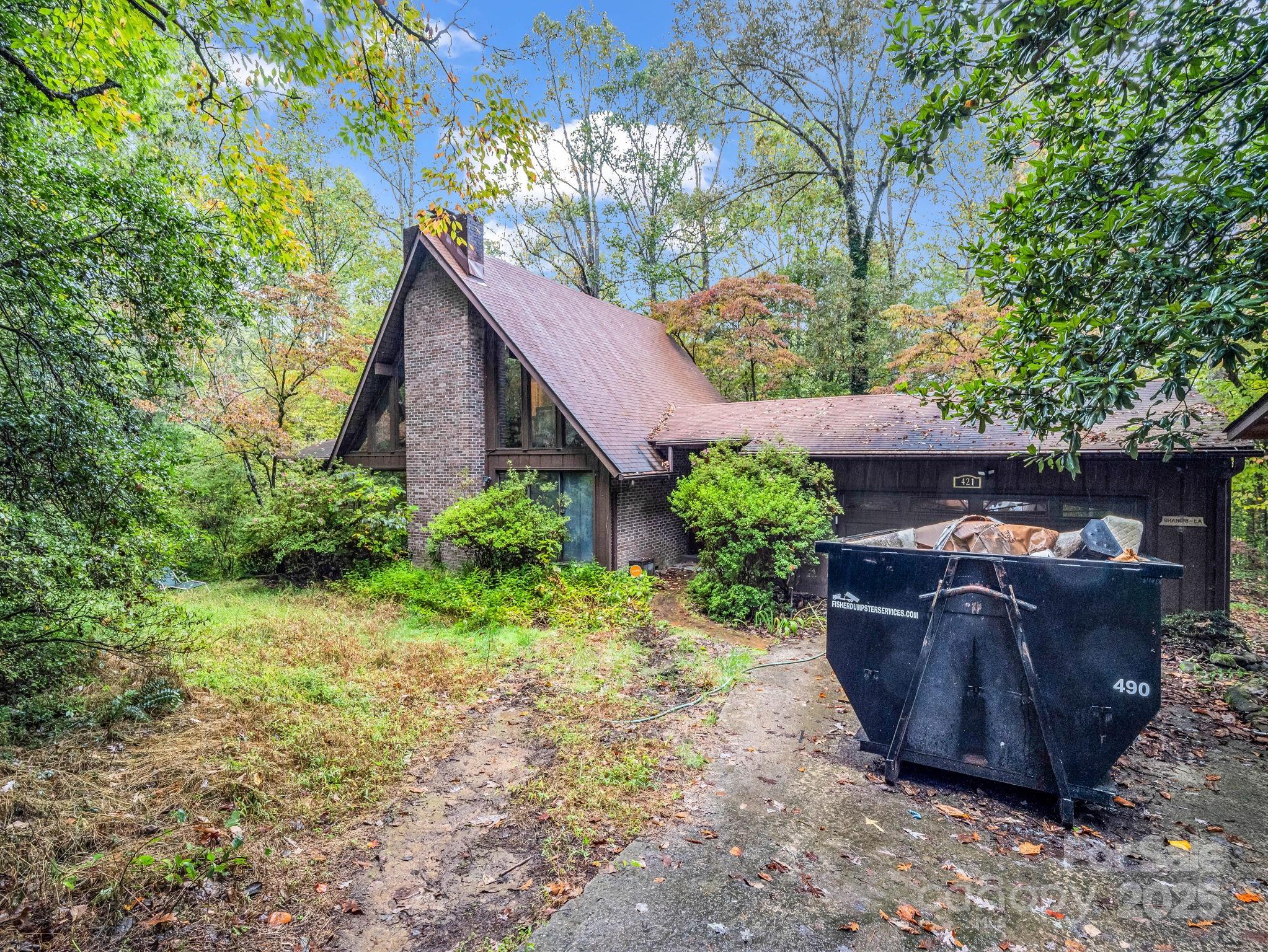 421 Chickadee Lane Brevard, NC 28712 - Photo 32 of 32 a couple of flower plants in front of house