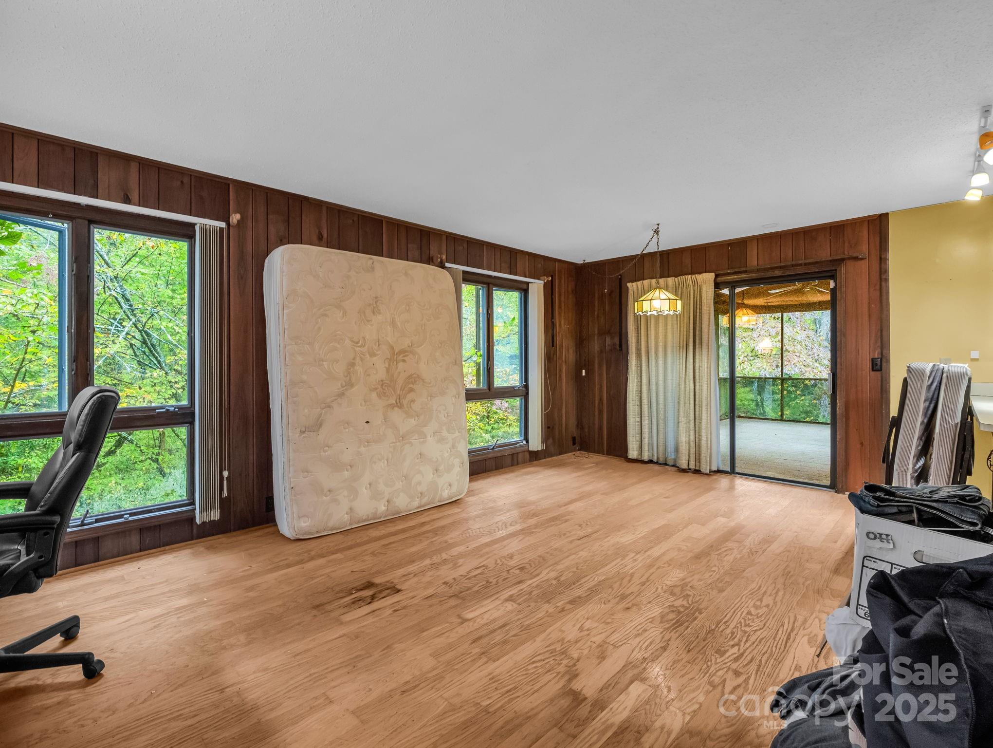 421 Chickadee Lane Brevard, NC 28712 - Photo 8 of 32 a view of an empty room with window a yard and front door