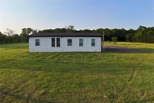 a house that has a yard in front of it