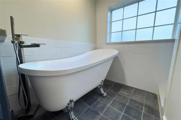 a white bath tub sitting in a bathroom