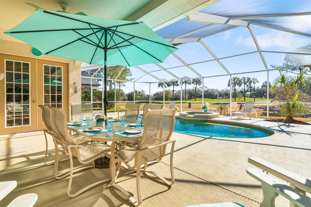 3408 Stonebridge Trail Valrico, FL 33596 - Photo 11 of 53 a view of a patio with a table and chairs under an umbrella