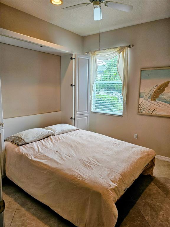 3408 Stonebridge Trail Valrico, FL 33596 - Photo 16 of 53 a bedroom with a bed and a window