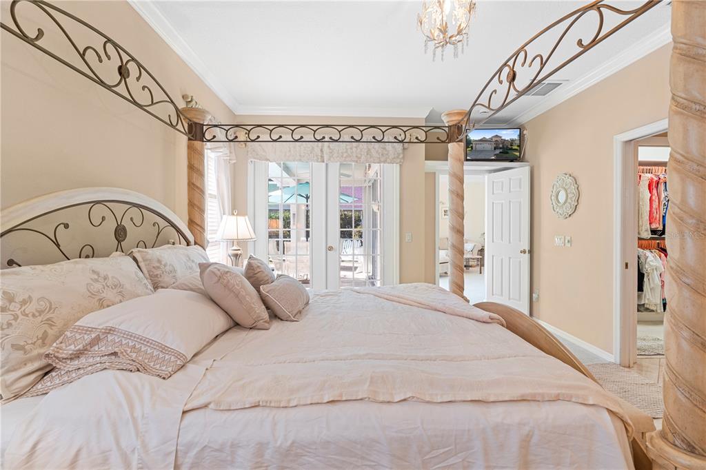 3408 Stonebridge Trail Valrico, FL 33596 - Photo 21 of 53 a bedroom with a large bed and a chandelier