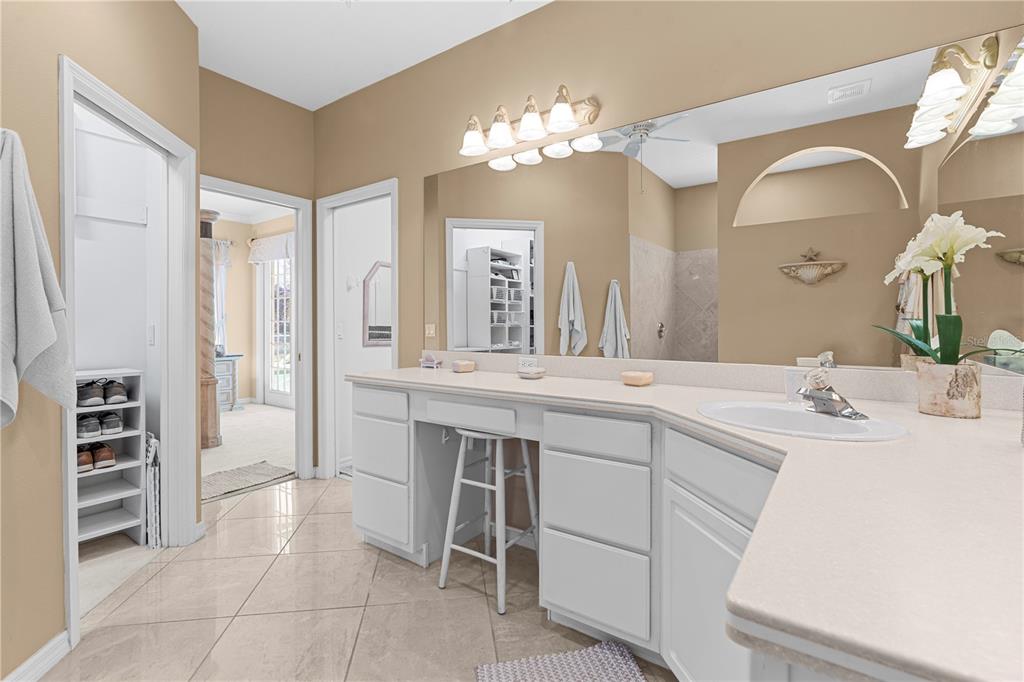 3408 Stonebridge Trail Valrico, FL 33596 - Photo 24 of 53 a spacious en suite bathroom with a double vanity sink and a mirror