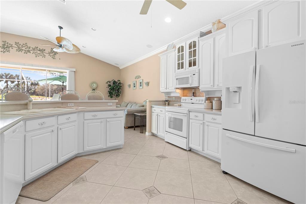 3408 Stonebridge Trail Valrico, FL 33596 - Photo 29 of 53 a kitchen with white cabinets and white appliances