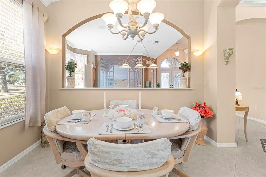 3408 Stonebridge Trail Valrico, FL 33596 - Photo 30 of 53 a dining room with furniture a chandelier and wooden floor