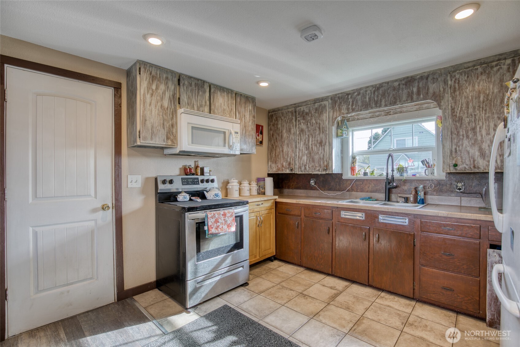 823 West 3rd Street Aberdeen, WA 98520 - Photo 10 of 40 a kitchen with stainless steel appliances granite countertop a sink and cabinets