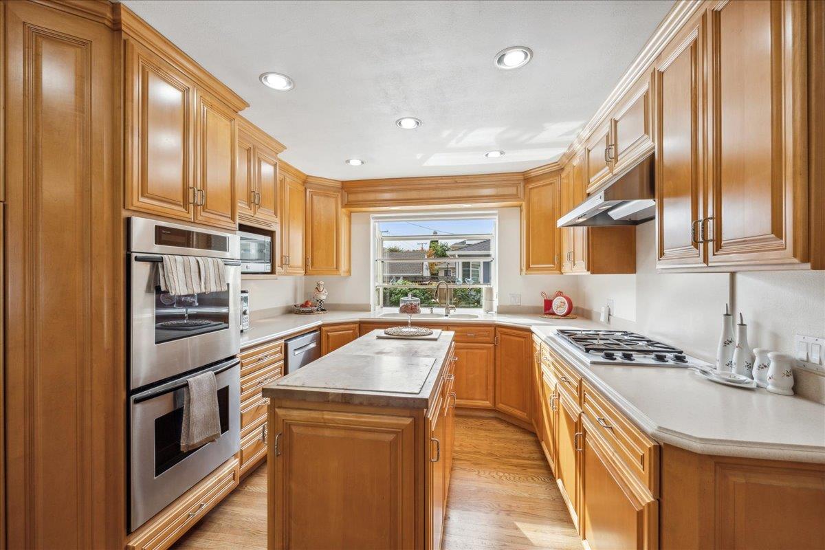 3726 Pasadena Drive San Mateo, CA 94403 - Photo 19 of 50 a kitchen that has a sink and a stove top oven