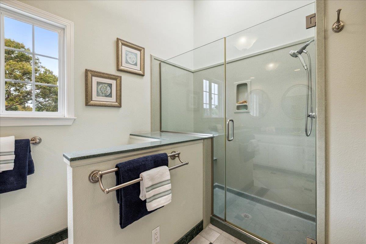 3726 Pasadena Drive San Mateo, CA 94403 - Photo 36 of 50 a bathroom with a sink a large mirror and a shower