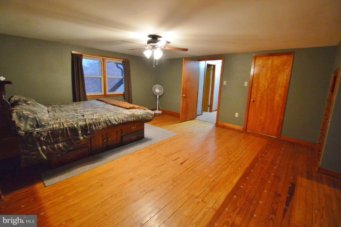 9 Hossler Road Manheim, PA 17545 - Photo 15 of 19 a spacious bedroom with a bed and a chandelier