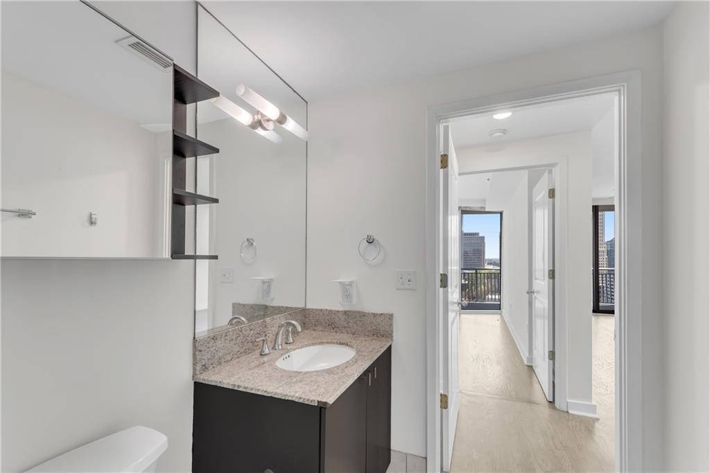 3338 Peachtree Road Northeast, Unit 1706 Atlanta, GA 30326 - Photo 19 of 37 a bathroom with a sink toilet vanity and shower