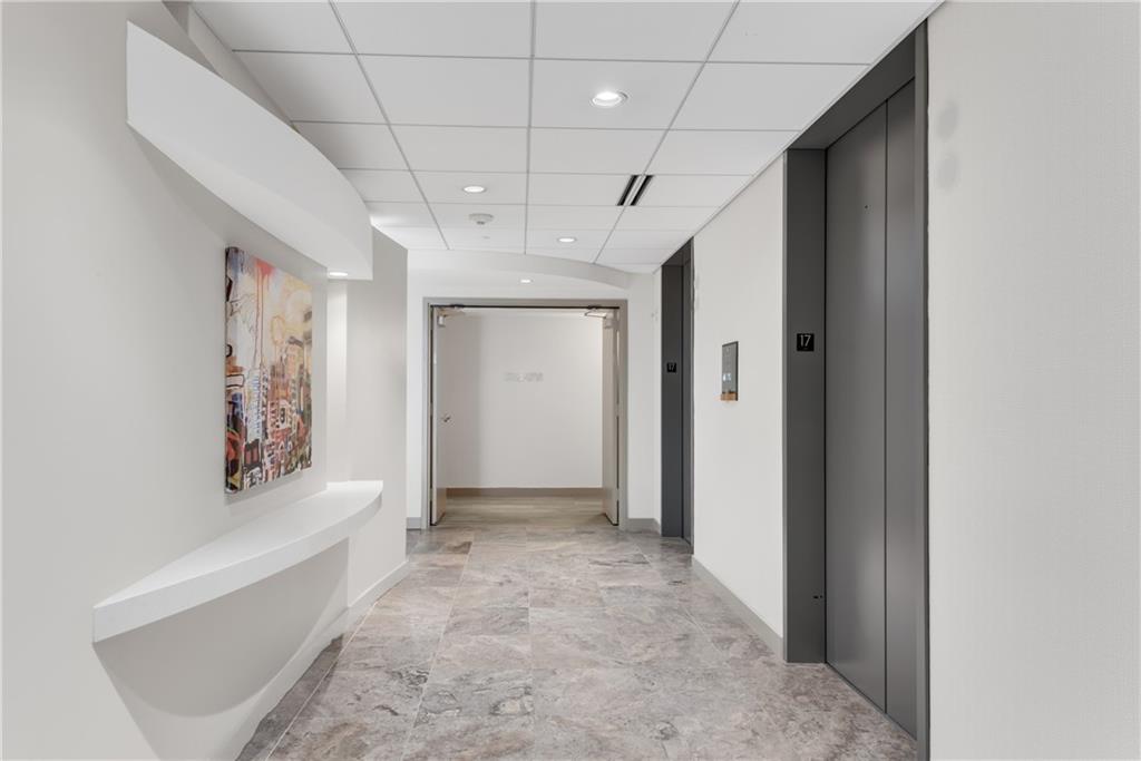 3338 Peachtree Road Northeast, Unit 1706 Atlanta, GA 30326 - Photo 21 of 37 a view of hallway with window and stairs