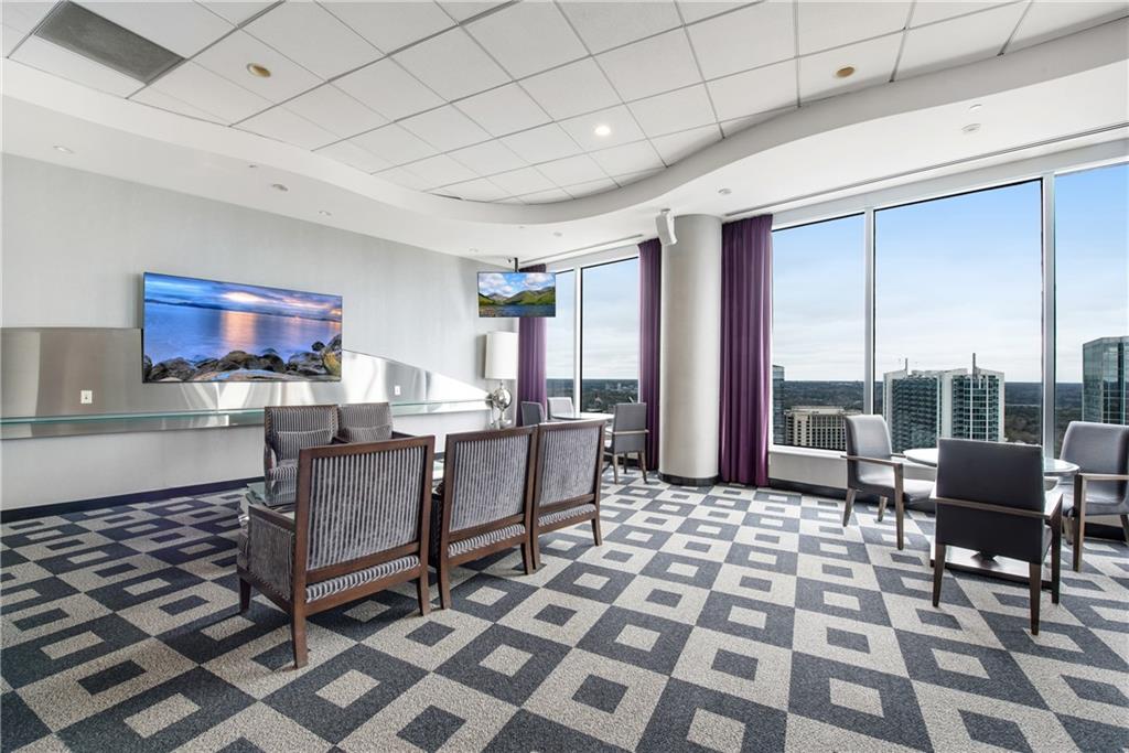 3338 Peachtree Road Northeast, Unit 1706 Atlanta, GA 30326 - Photo 32 of 37 a living room with furniture and a floor to ceiling window