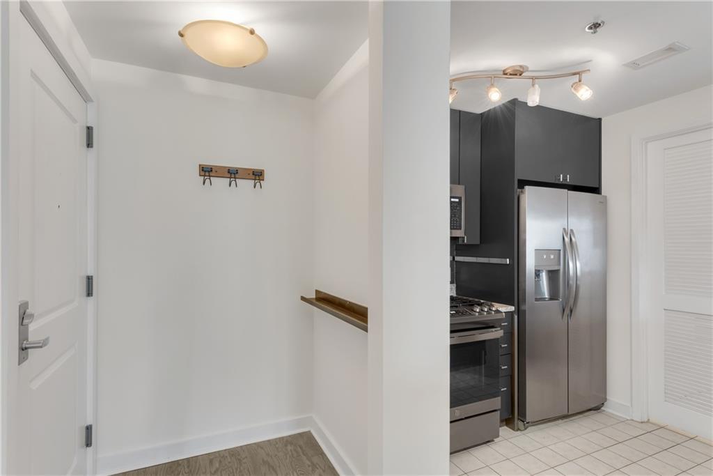 3338 Peachtree Road Northeast, Unit 1706 Atlanta, GA 30326 - Photo 5 of 37 a kitchen with a refrigerator and a sink