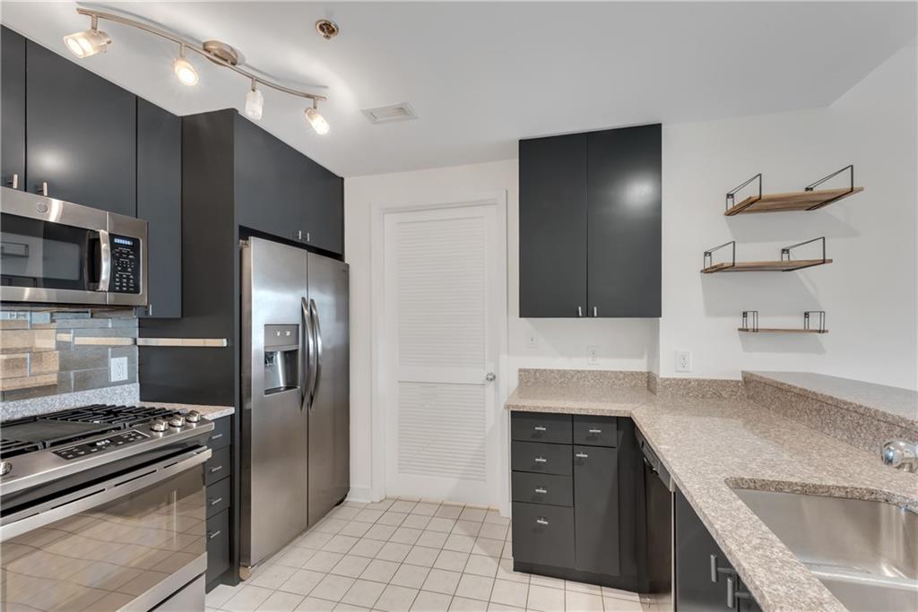 3338 Peachtree Road Northeast, Unit 1706 Atlanta, GA 30326 - Photo 6 of 37 a kitchen with a sink stove and refrigerator