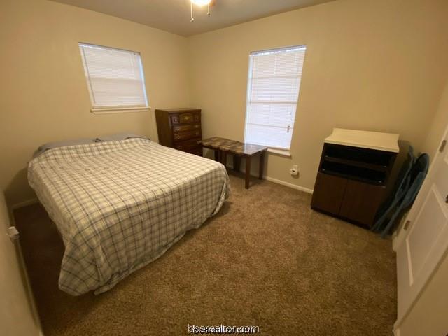3005 1st Street Bryan, TX 77801 - Photo 11 of 18 a bedroom with a bed and a dresser