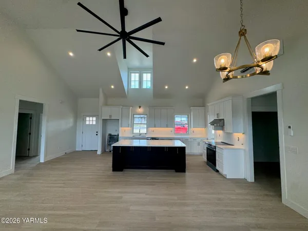 a large kitchen with stainless steel appliances a lot of counter space and a sink