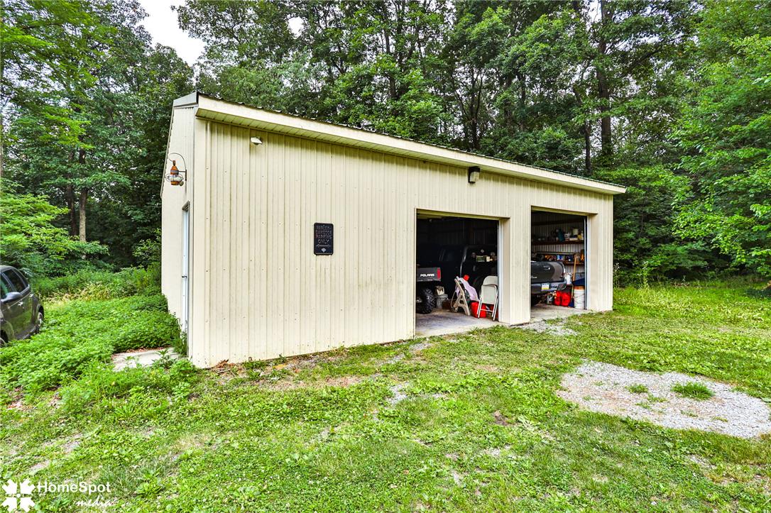 3795 Rhoades Road Kempton, PA 19529 - Photo 36 of 42 A detached two-car garage, offering ample storage or workshop space, nestled among green foliage.