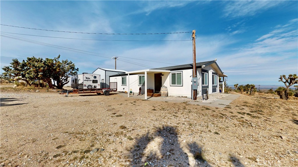 9322 Spruce Road Pinon Hills, CA 92372 - Photo 1 of 1 a view of a house with a snow in the yard