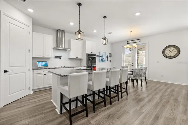 a large kitchen with a table and chairs