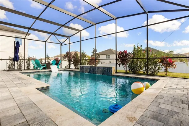 a view of swimming pool with a patio