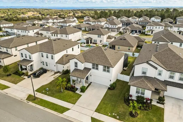 an aerial view of multiple houses with a yard