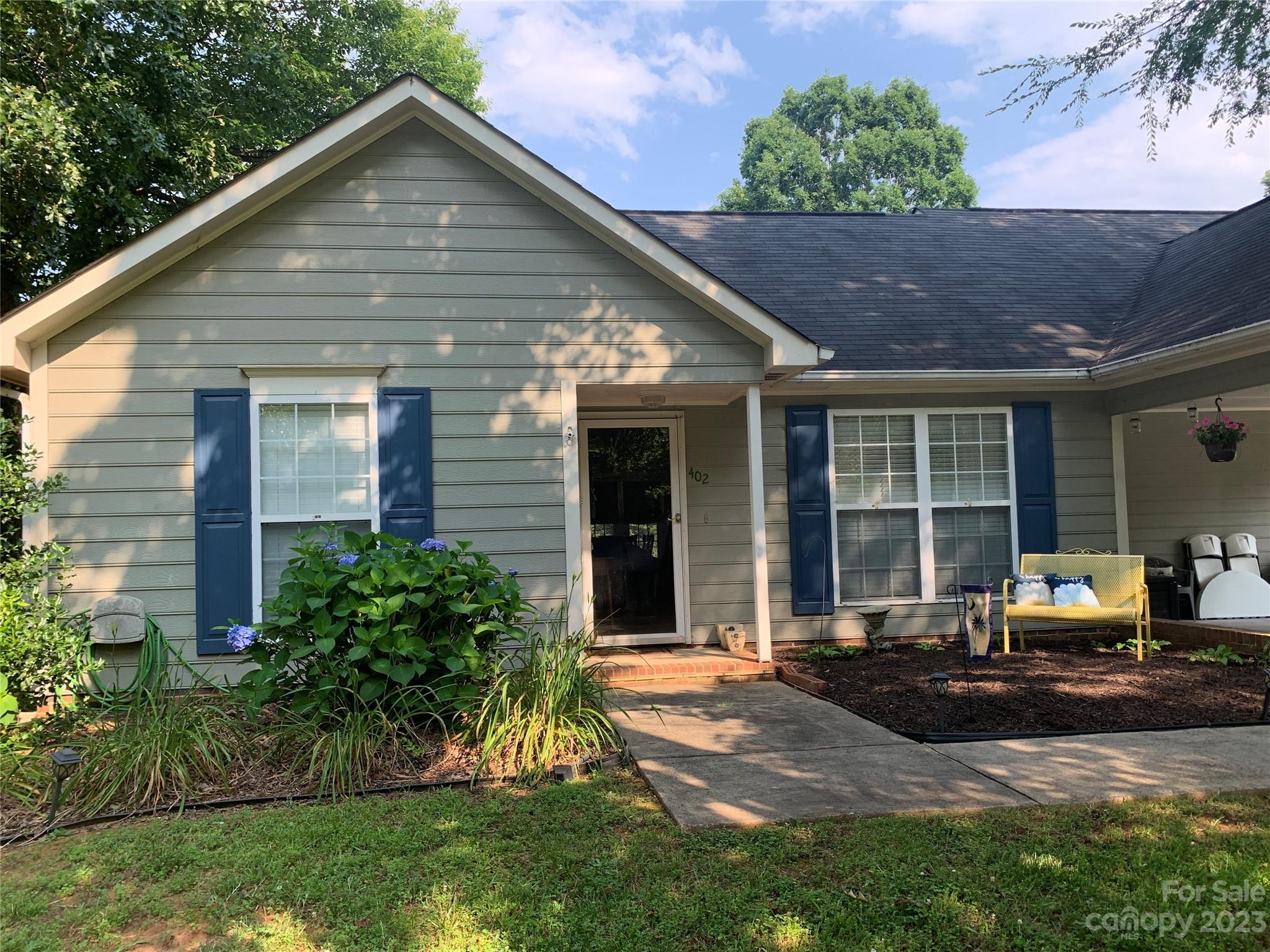 a front view of a house with a yard and outdoor seating