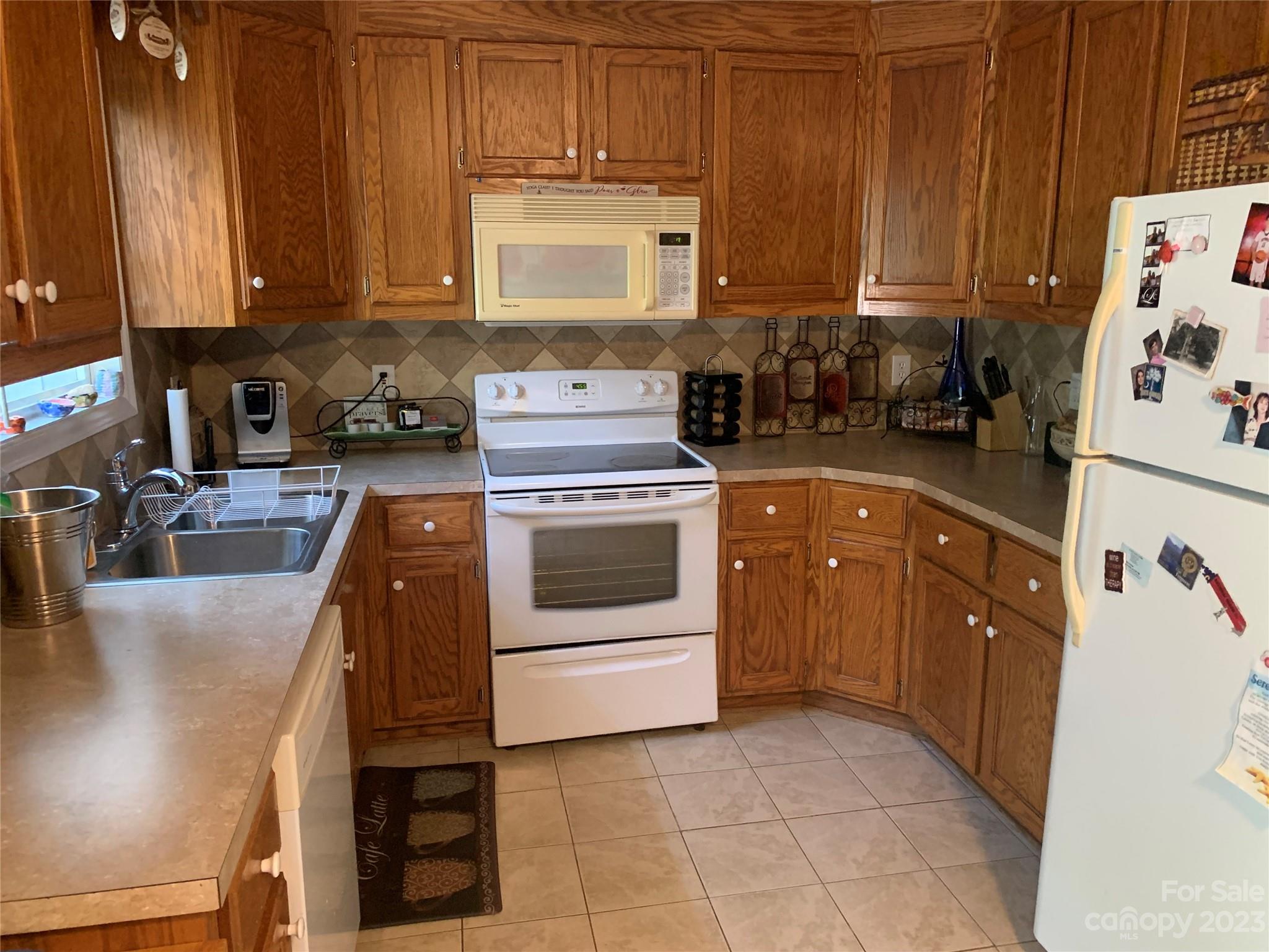 402 Split Oak Trail Gastonia, NC 28052 - Photo 16 of 23 a kitchen with a stove a sink and a refrigerator