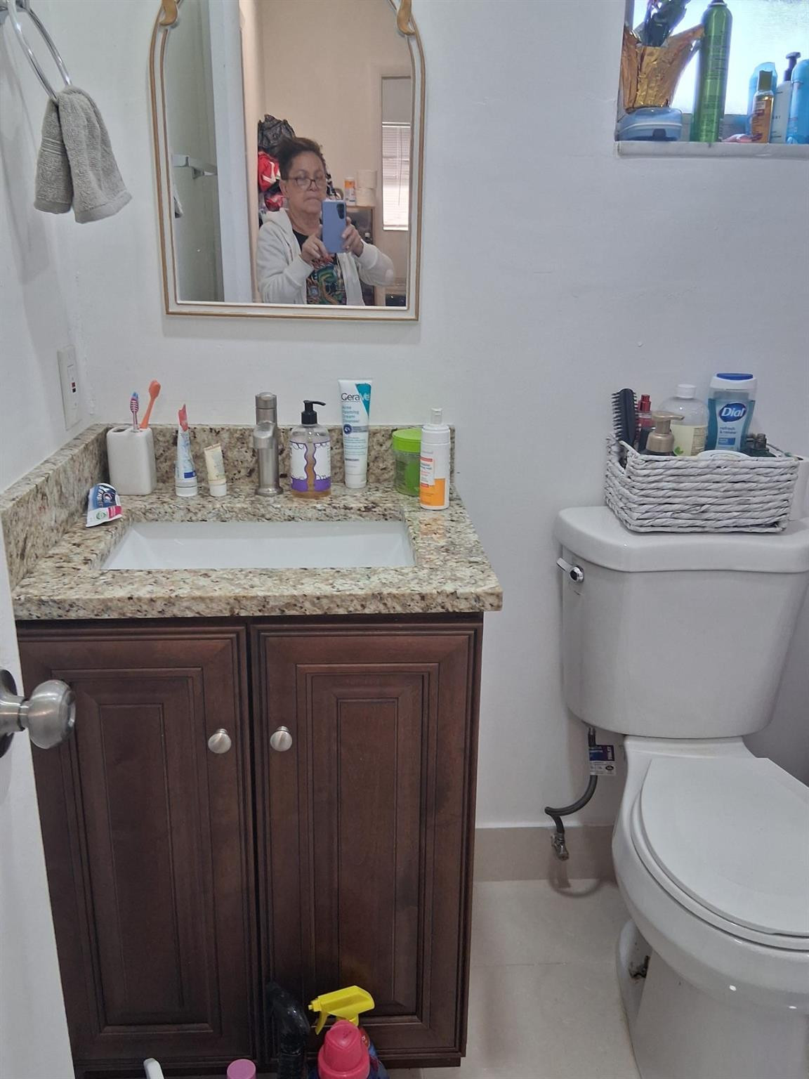 338 Southwest 15th Street, Unit 338 Dania Beach, FL 33004 - Photo 11 of 14 a bathroom with a granite countertop toilet sink and a mirror
