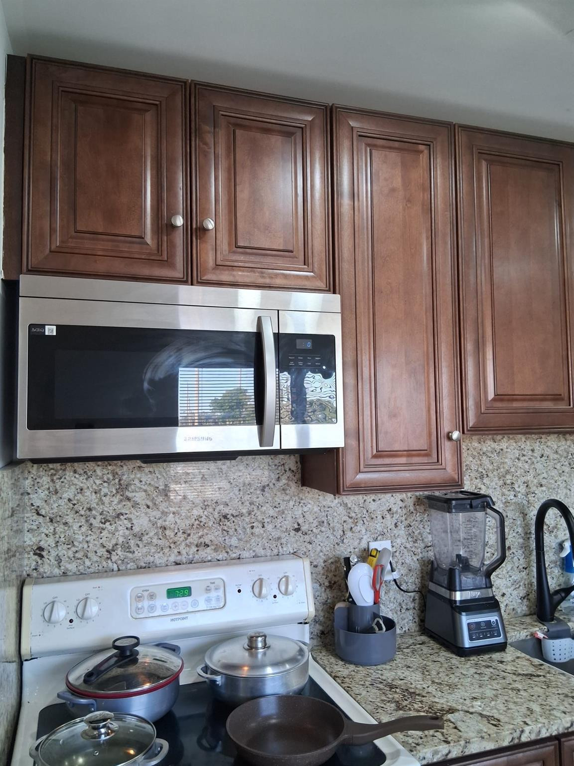 338 Southwest 15th Street, Unit 338 Dania Beach, FL 33004 - Photo 2 of 14 a kitchen with stainless steel appliances granite countertop a sink stove and cabinets