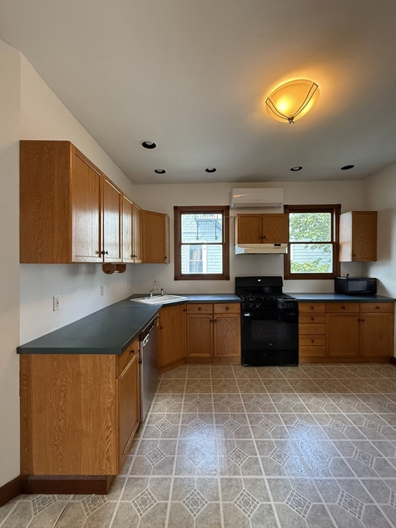 32-34 Etna Street, Unit 2 Boston, MA 02135 - Photo 2 of 12 a large kitchen with a large counter top and stainless steel appliances