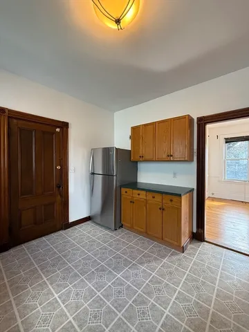 a view of a kitchen with a sink and a refrigerator